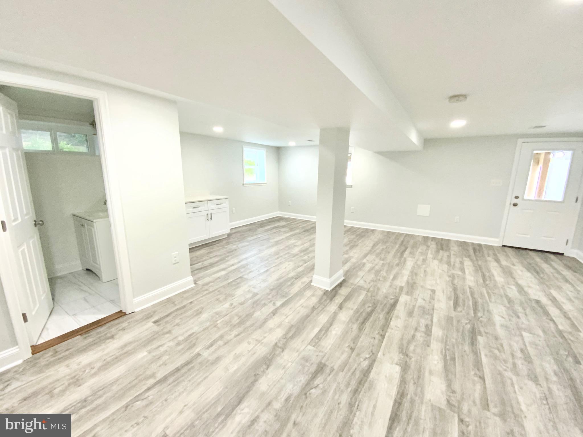 1318 Ingraham Street Northwest Washington, DC 20011 - Photo 28 of 35 a view of a big room with wooden floor and windows
