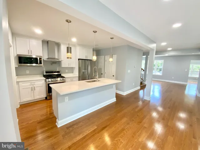 a large kitchen with stainless steel appliances lots of counter top space