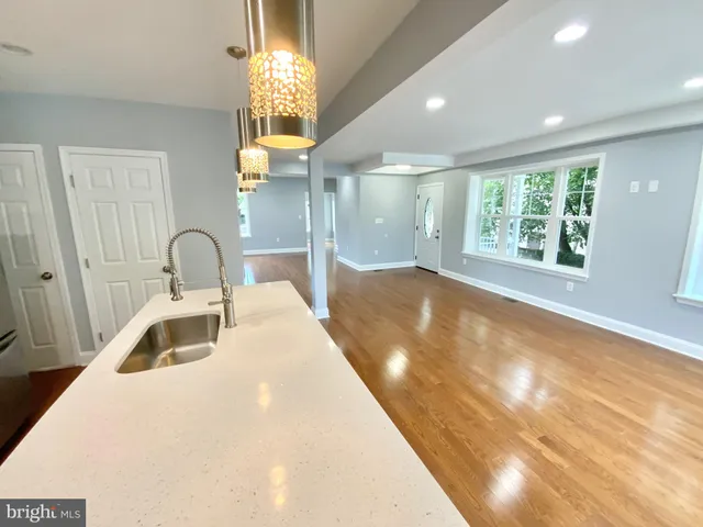 a bathroom with a sink a large mirror and a bathtub