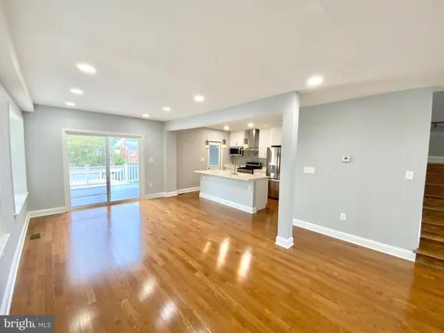 a view of a kitchen with wooden floor and a kitchen