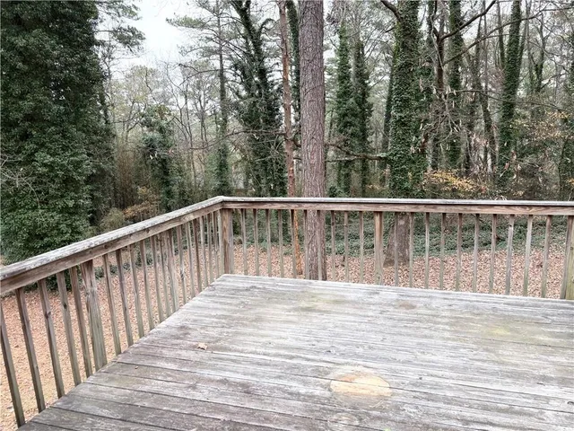 a view of a house with a yard and tree