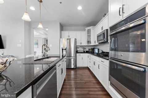a kitchen with stainless steel appliances a sink stove and refrigerator