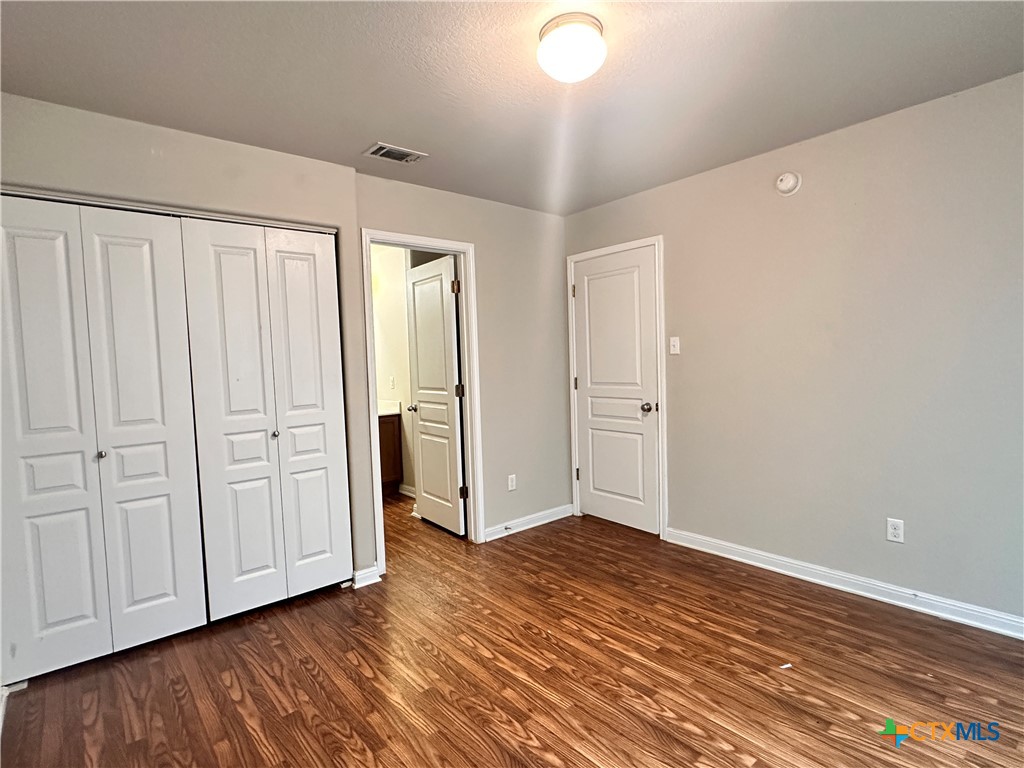 264 Trestle Tree, Unit A San Marcos, TX 78666 - Photo 13 of 17 a view of an empty room with closet and a window