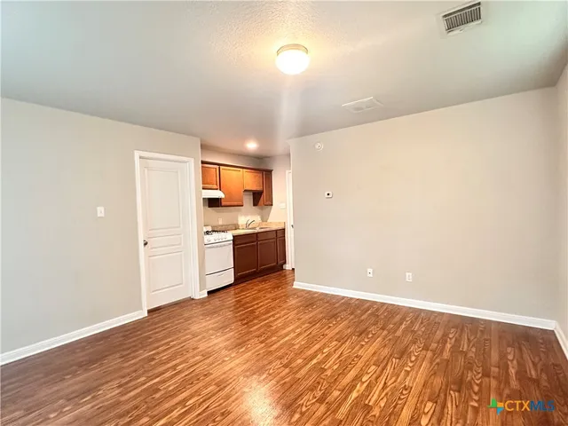 a view of a kitchen with a sink and a stove top oven