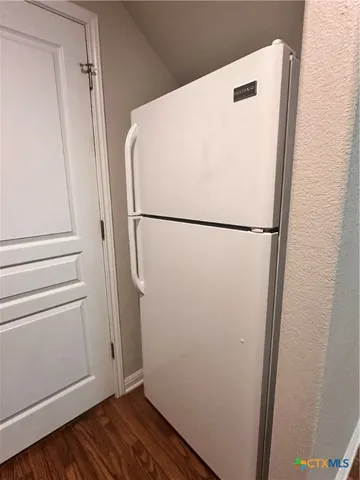 a white refrigerator freezer sitting inside of a kitchen