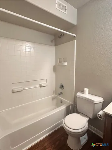 a bathroom with a toilet and a bathtub