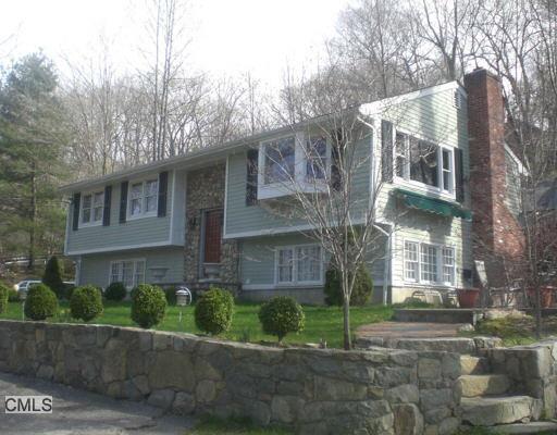750 Ethan Allen Highway Ridgefield, CT 06877 - Photo 1 of 1 a view of a brick house next to a yard with large trees