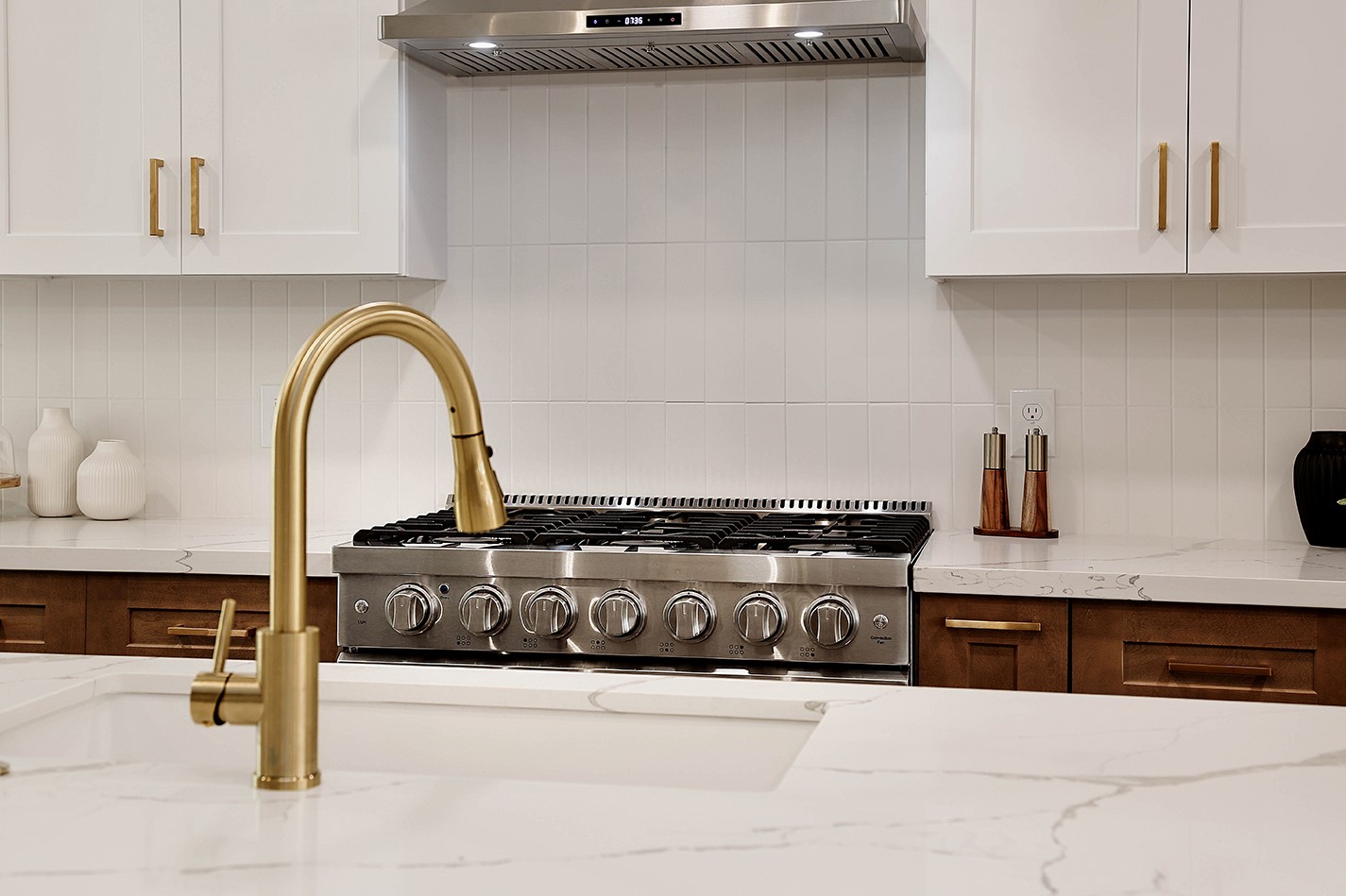 19410 Craigchester Lane Spring, TX 77388 - Photo 12 of 32 Gorgeous gold pull-down faucet ties with the gold cabinet pulls perfectly. Custom tile backsplash ties upper cabinets, counters and lower cabinets together seamlessly.