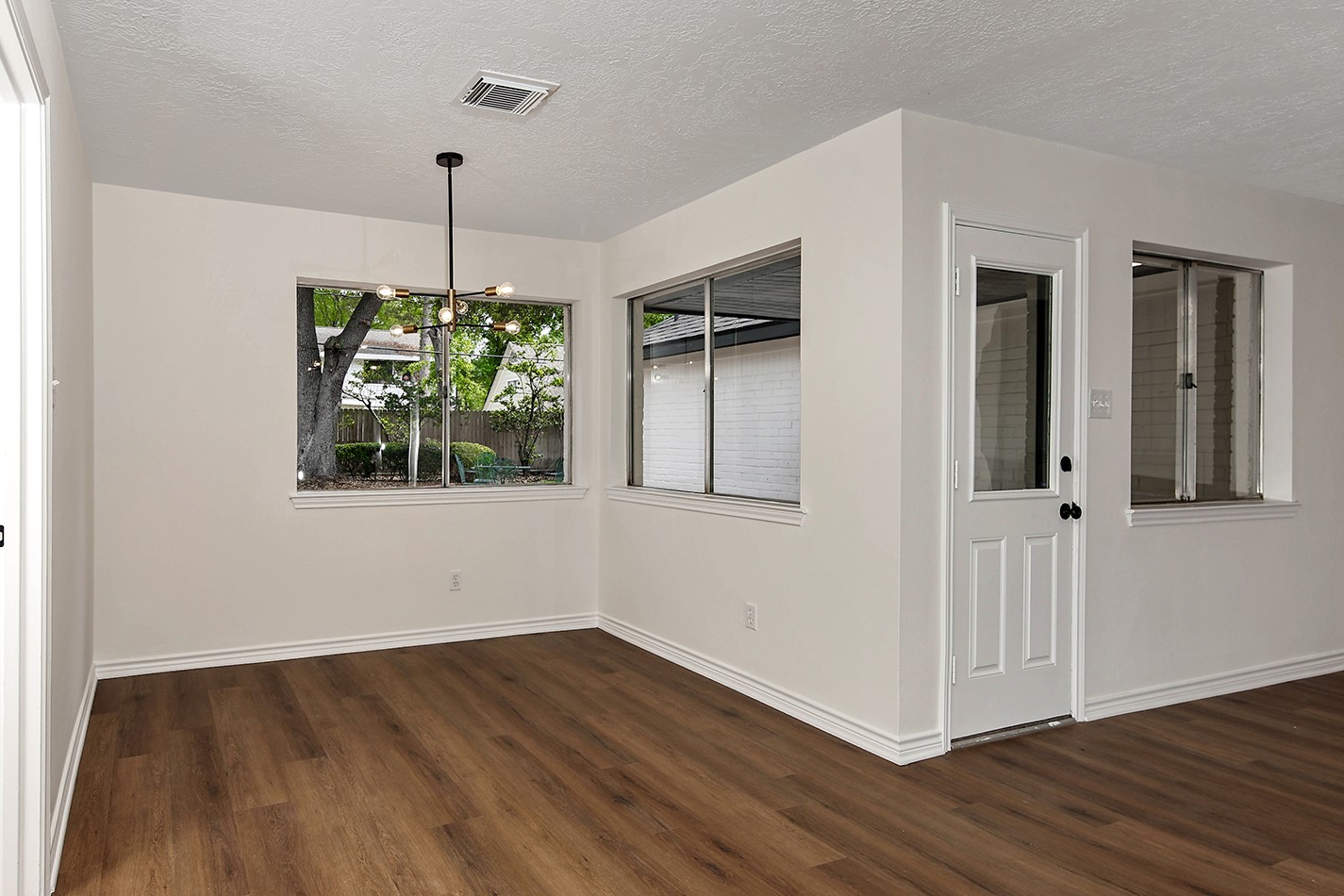 19410 Craigchester Lane Spring, TX 77388 - Photo 14 of 32 Dining area has a modern hanging light with great views to private backyard.