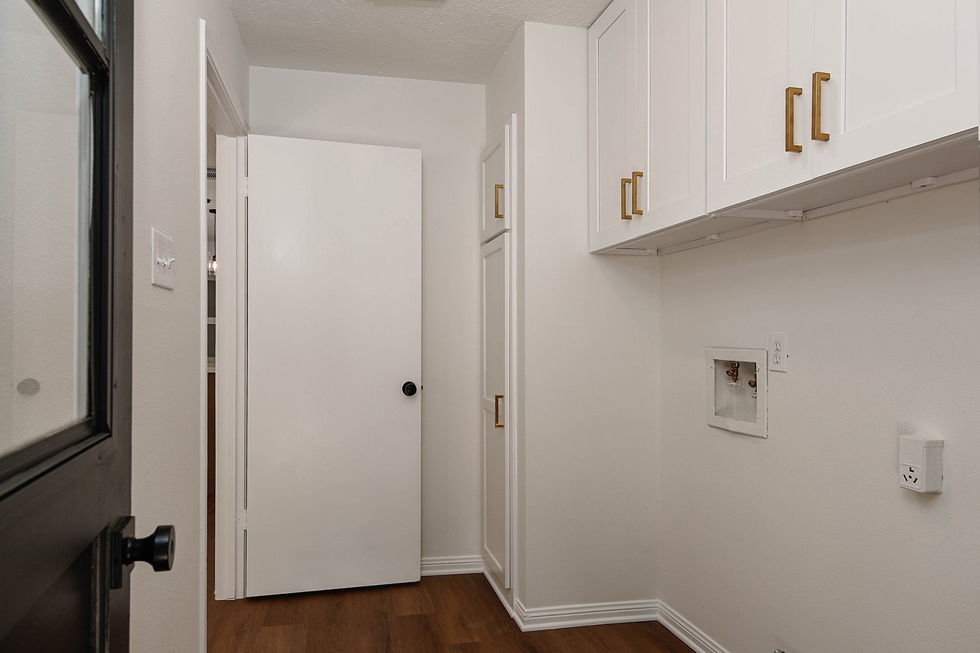 19410 Craigchester Lane Spring, TX 77388 - Photo 15 of 32 All new paint and custom cabinets including a convenient broom closet in laundry room with modern gold pulls.