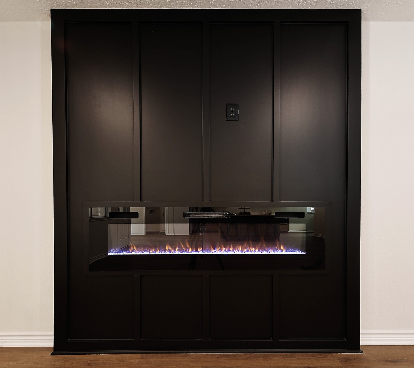 19410 Craigchester Lane Spring, TX 77388 - Photo 17 of 32 Paneled wood wall in living room has modern 5-foot electric fireplace with convenient outlet above for TV/Media, adding architectural interest, texture and dimension to the space.