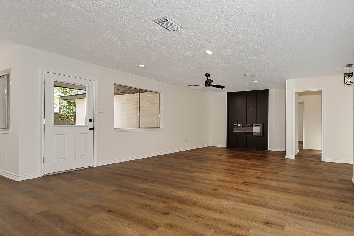 19410 Craigchester Lane Spring, TX 77388 - Photo 18 of 32 a view of an empty room with a window and wooden floor
