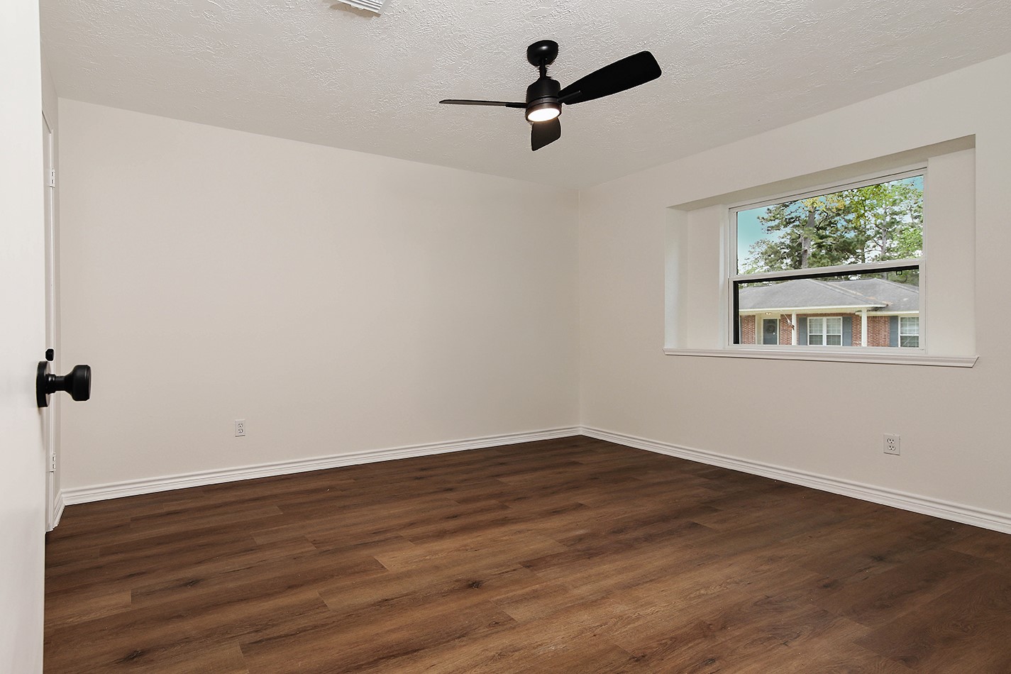 19410 Craigchester Lane Spring, TX 77388 - Photo 23 of 32 Bedroom 2 has new paint in soft neutral tone to go with any decor, new fan, window, luxury vinyl wood plank flooring and new fixtures in walk-in closet. Direct access to Bath 2.