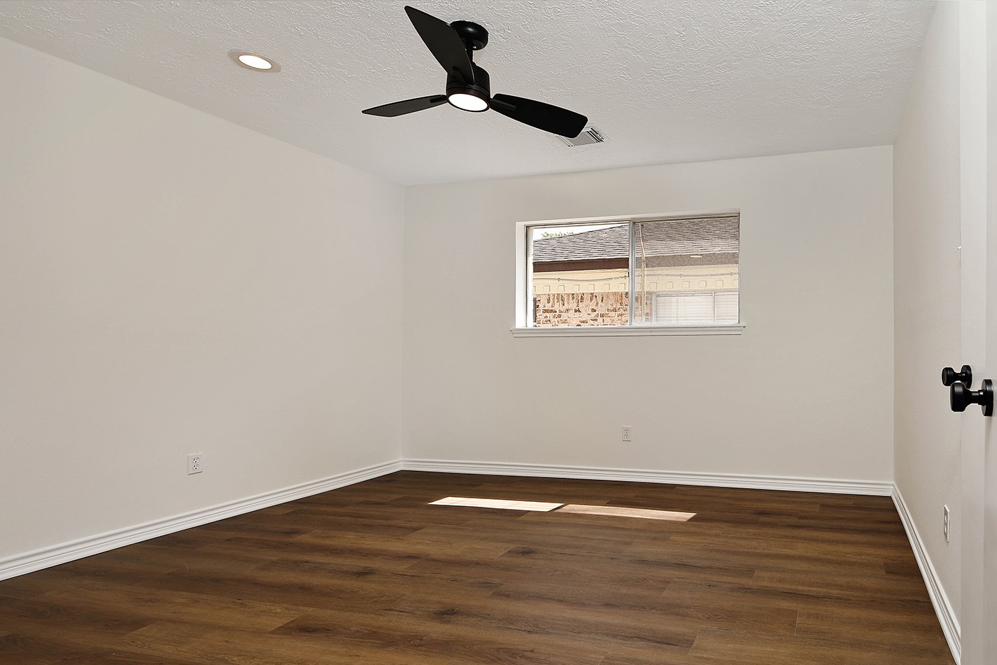 19410 Craigchester Lane Spring, TX 77388 - Photo 24 of 32 Bedroom 3 has new paint in pleasing color to go with any decor, recessed lighting, fan, door hardware, luxury vinyl wood plant flooring, and new fixtures in walk-in closet.