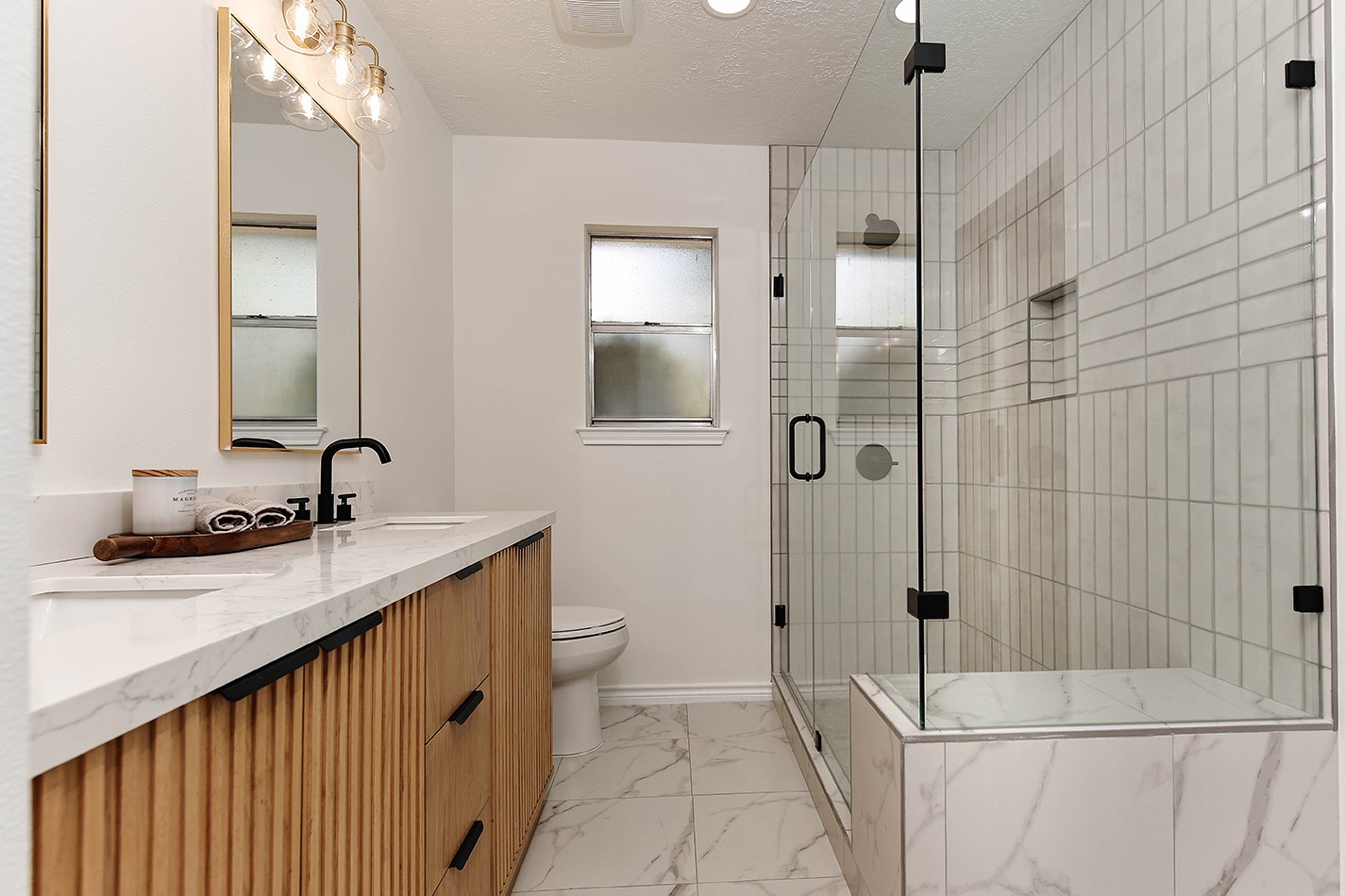 19410 Craigchester Lane Spring, TX 77388 - Photo 29 of 32 Fabulous new walk-in shower has bench, frameless glass enclosure, and custom tile with recessed niche for bottle storage.