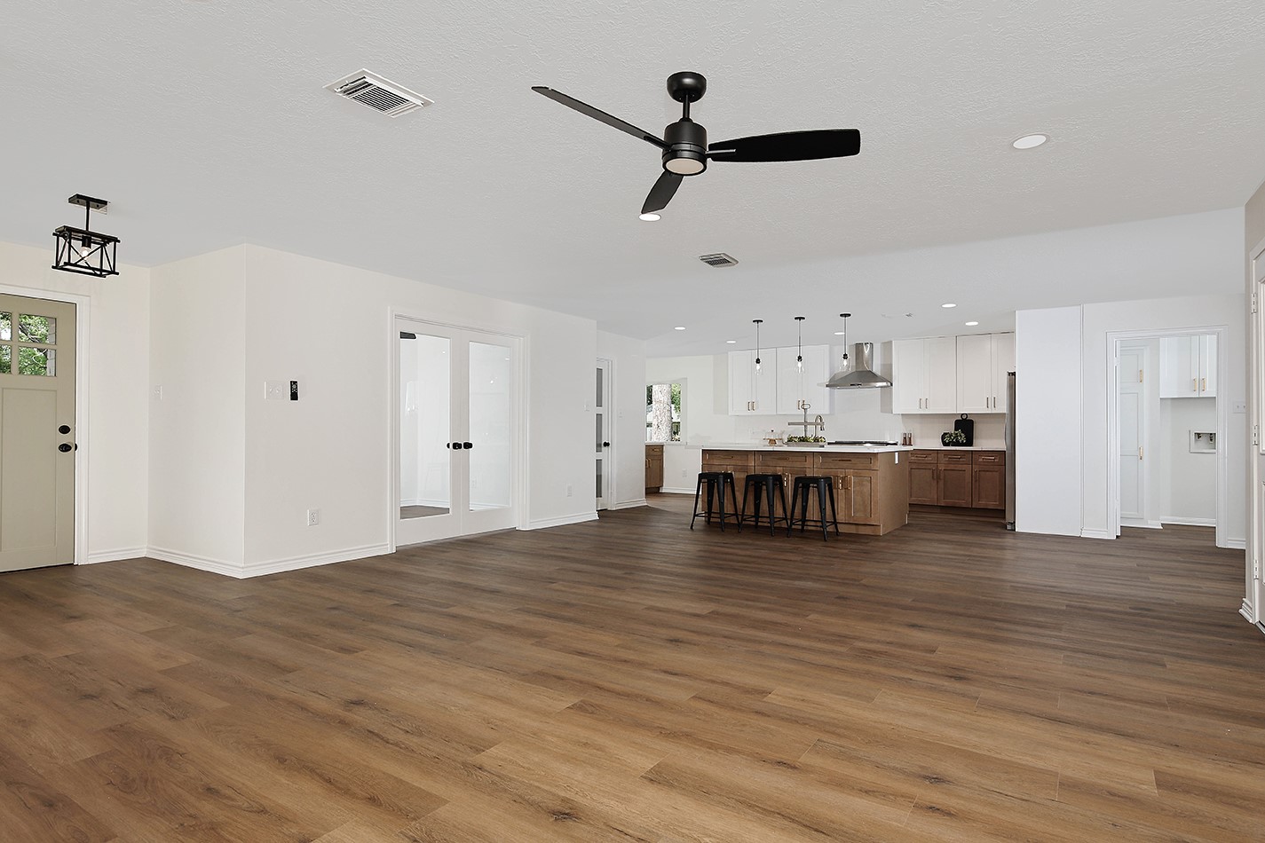 19410 Craigchester Lane Spring, TX 77388 - Photo 6 of 32 Reimagined interior to an open concept plan with adjoining main living areas, creating space for a private study, and extended kitchen to include central island, coffee bar and walk-in pantry.