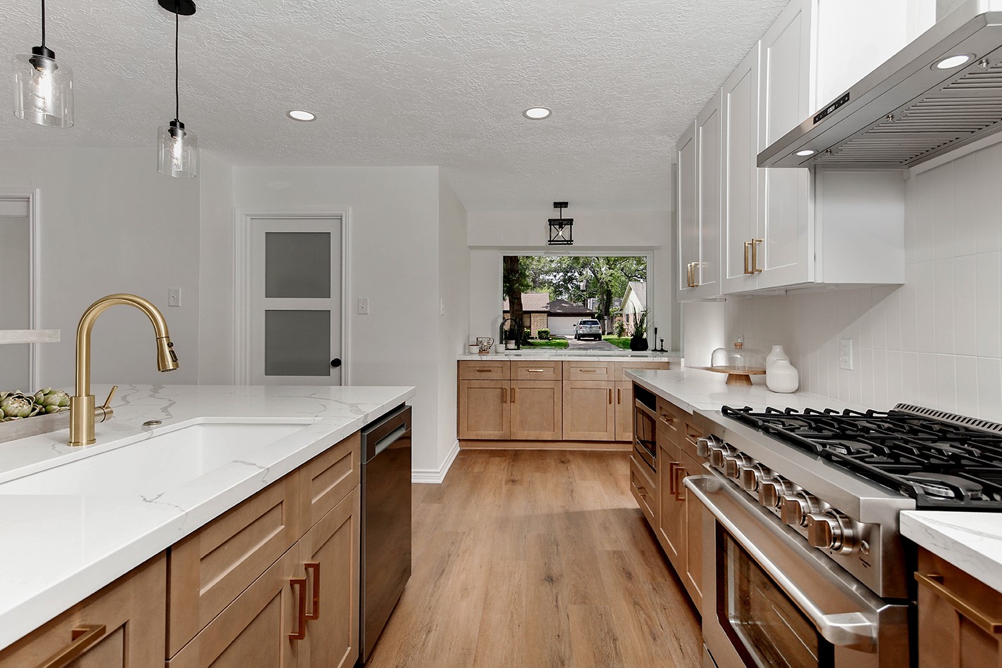 19410 Craigchester Lane Spring, TX 77388 - Photo 9 of 32 Premium white quartz counters with gray veining lend to an elevated, elegant style in kitchen.