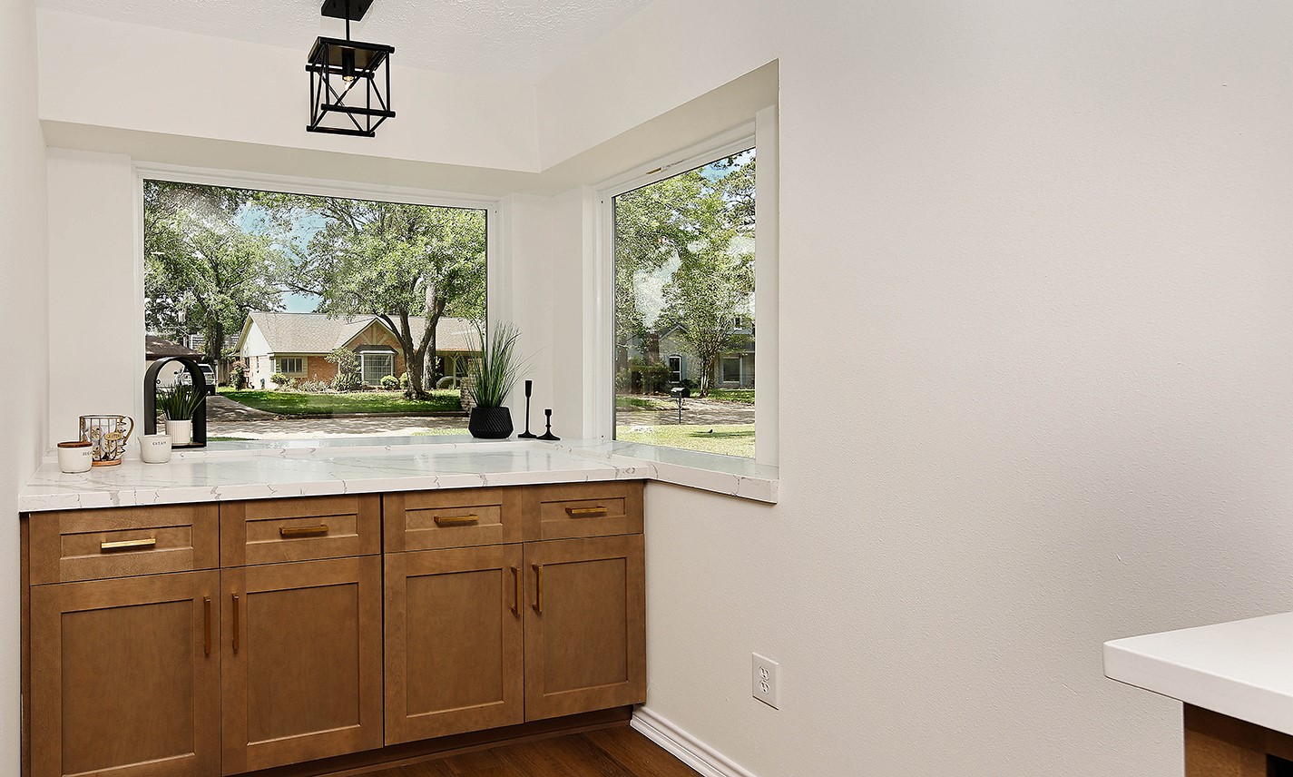 19410 Craigchester Lane Spring, TX 77388 - Photo 10 of 32 Custom coffee bar is an extension of the kitchen providing additional counter space and cabinet storage. Two beautiful plate glass windows have deep sills for plants, herbs or decor.