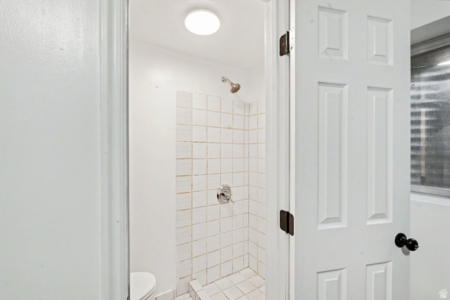 3689 Lasso Loop Circle Magna, UT 84044 - Photo 19 of 26 3rd bathroom with Shower enclosure featuring white square tile, chrome fixtures, and a ceiling-mounted light