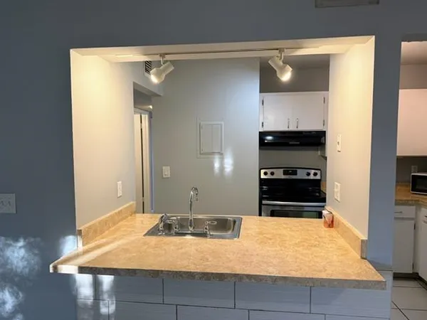 a kitchen with a stove and a refrigerator