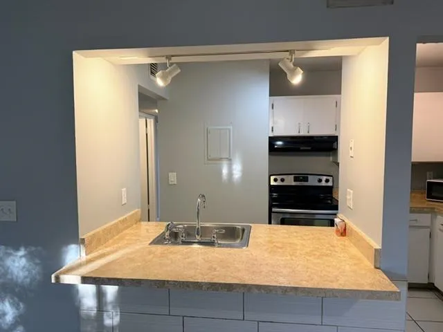 a kitchen with a stove and a refrigerator