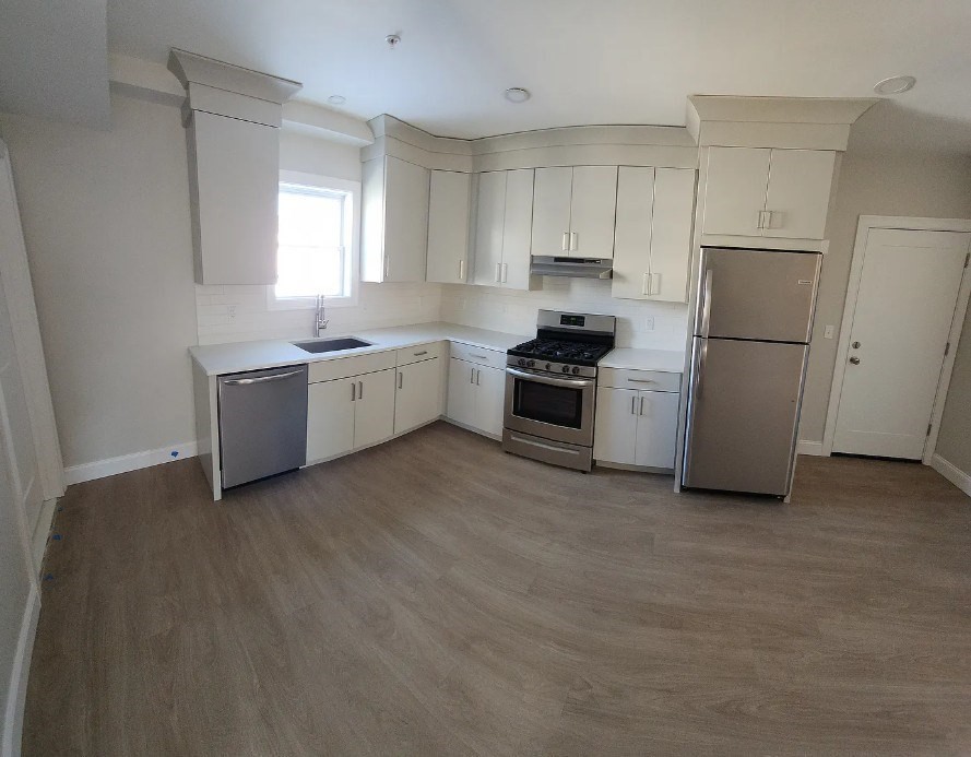 a kitchen with a white stove top oven and refrigerator