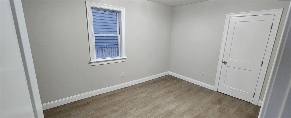 322 Brownell Street, Unit 1E Fall River, MA 02720 - Photo 5 of 6 a view of an empty room with closet and a window