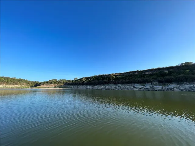 a view of a lake with houses in the background