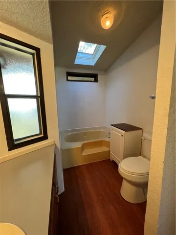 a bathroom with a toilet tub and sink