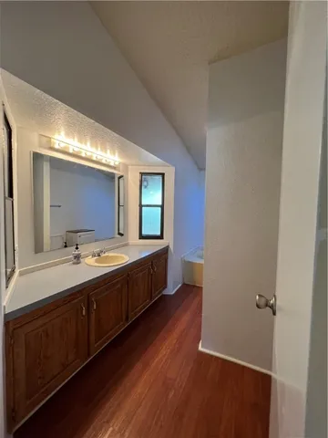 a large bathroom with a double vanity sink and a mirror