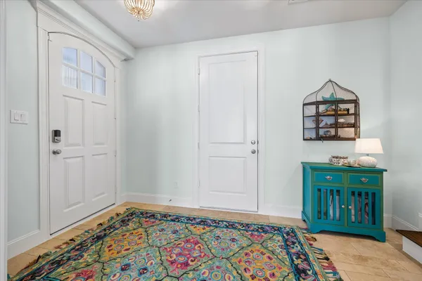 an entryway with a rug
