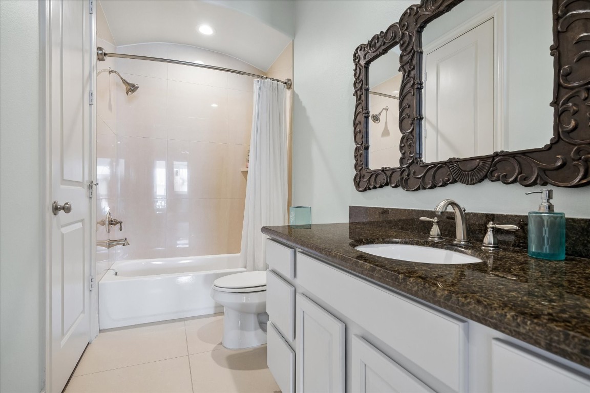 246 East 28th Street Houston, TX 77008 - Photo 14 of 27 a bathroom with a granite countertop sink a toilet a mirror and shower