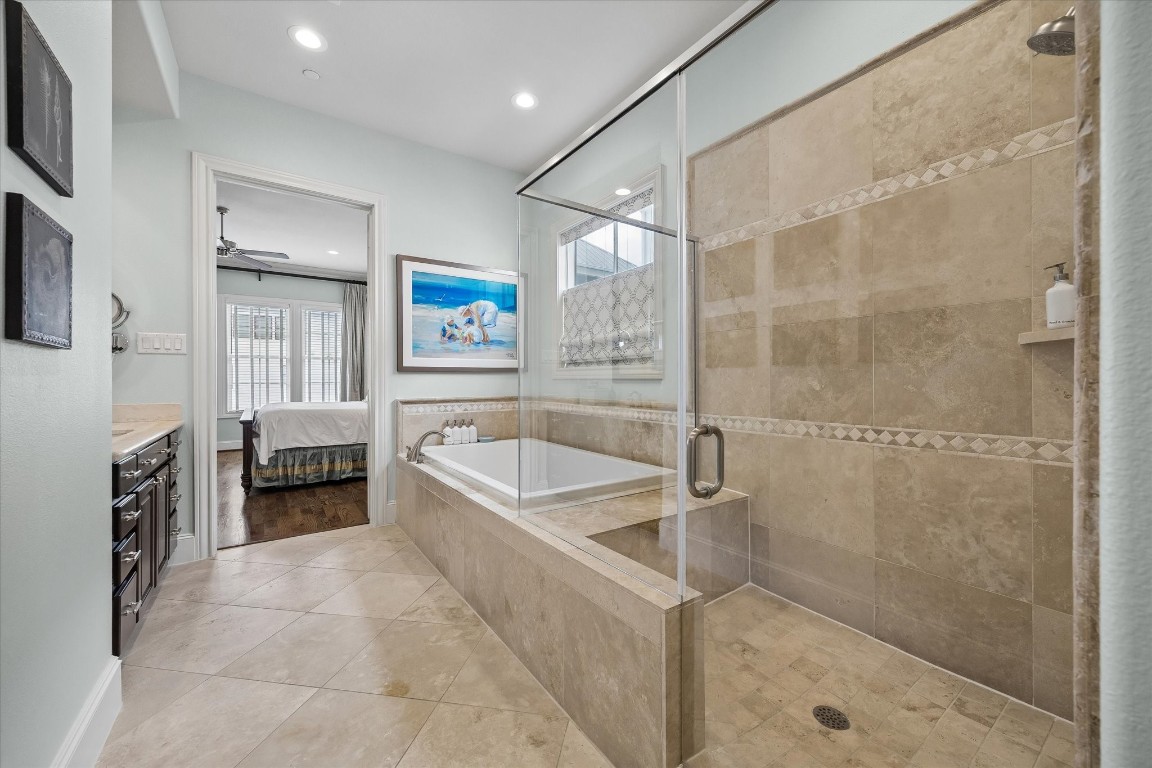 246 East 28th Street Houston, TX 77008 - Photo 17 of 27 a spacious en suite bathroom with a granite countertop tub sink a vanity and a shower