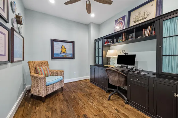 a living room with furniture a ceiling fan and a window