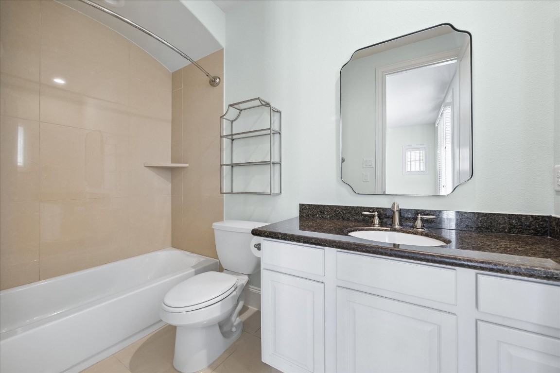 246 East 28th Street Houston, TX 77008 - Photo 23 of 27 a bathroom with a granite countertop toilet sink and mirror