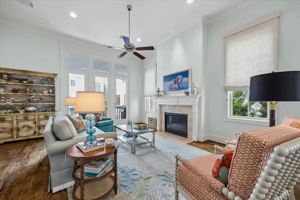 a living room with furniture a fireplace and a flat screen tv