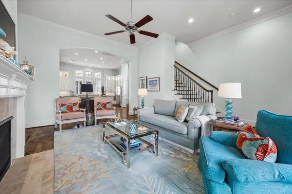 a living room with furniture and a chandelier