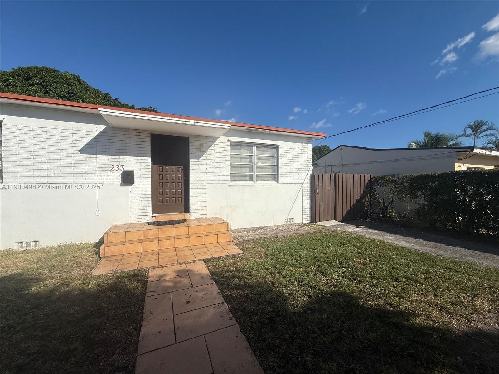 233 Northwest 45th Avenue, Unit 233 Miami, FL 33126 - Photo 1 of 11 a front view of a house with yard