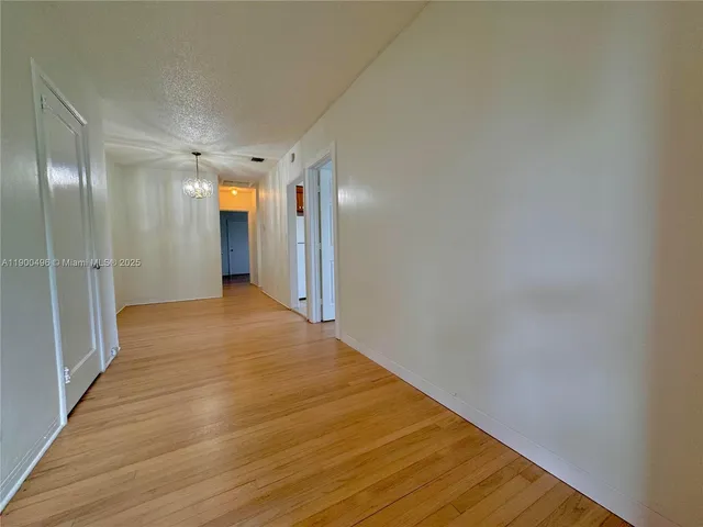 a view of hallway with wooden floor