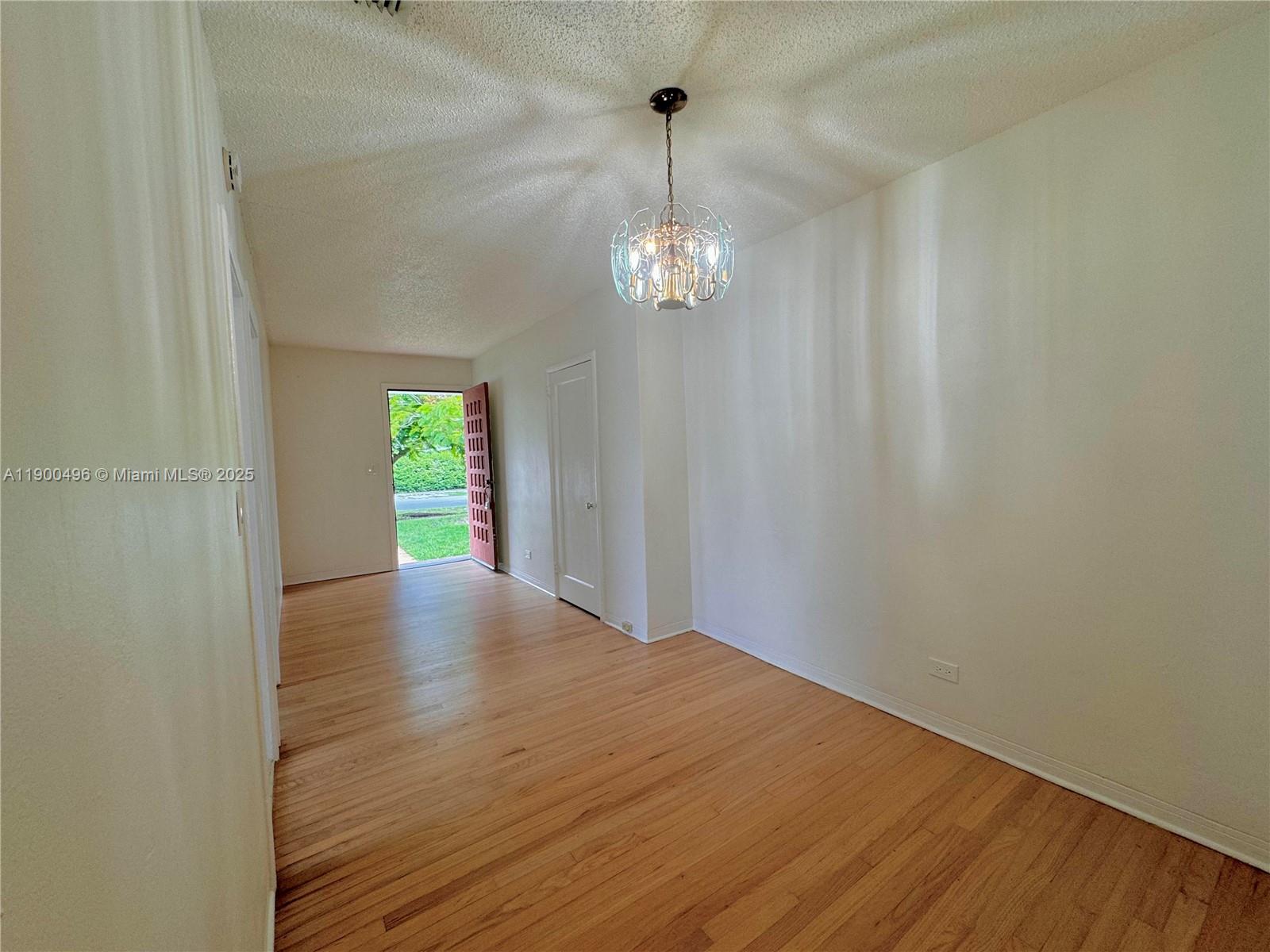 233 Northwest 45th Avenue, Unit 233 Miami, FL 33126 - Photo 3 of 11 a view of empty room with wooden floor and fan