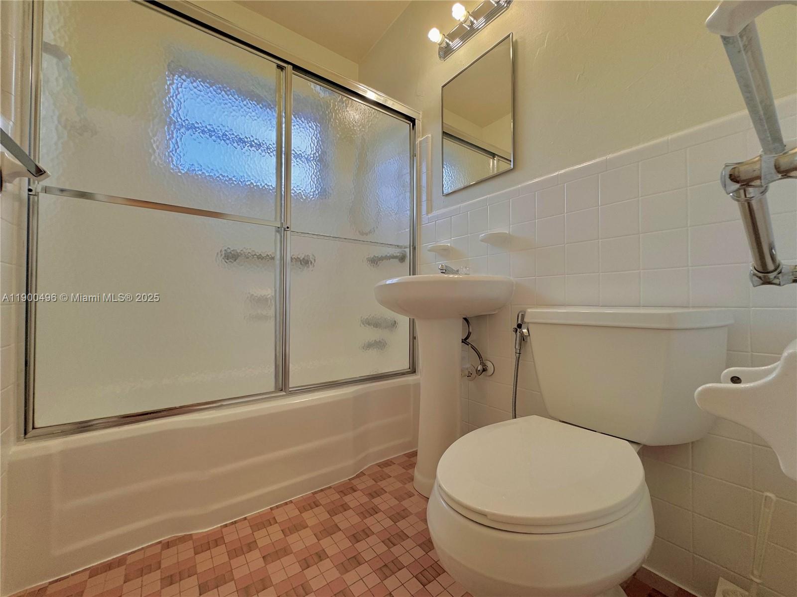 233 Northwest 45th Avenue, Unit 233 Miami, FL 33126 - Photo 8 of 11 a bathroom with a toilet and a shower