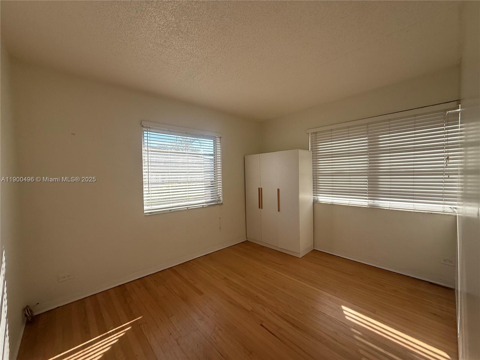 233 Northwest 45th Avenue, Unit 233 Miami, FL 33126 - Photo 9 of 11 a view of an empty room with a window