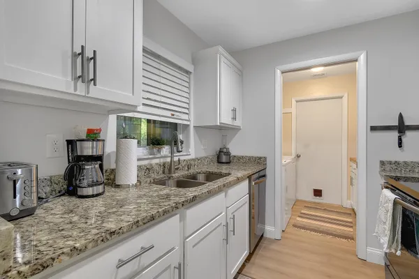 a kitchen with sink and cabinets
