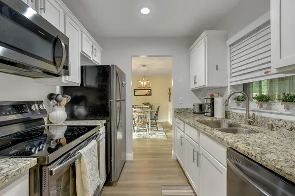 a kitchen with a sink stove and refrigerator