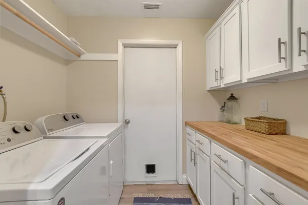 a utility room with sink dryer and washer