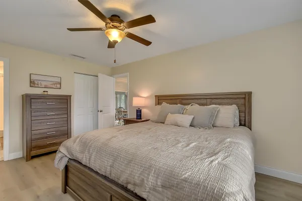 a bedroom with a bed and a chandelier