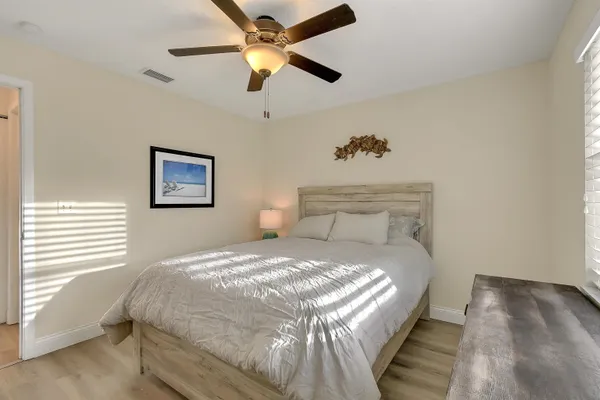 a bedroom with a bed and a painting on the wall