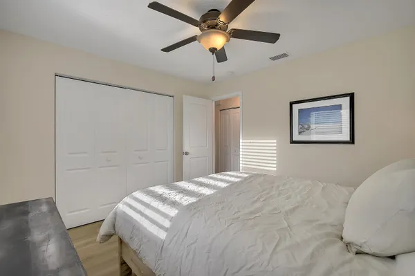 a bedroom with a bed and a chandelier