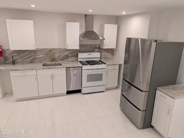 a view of a storage & utility room with a sink