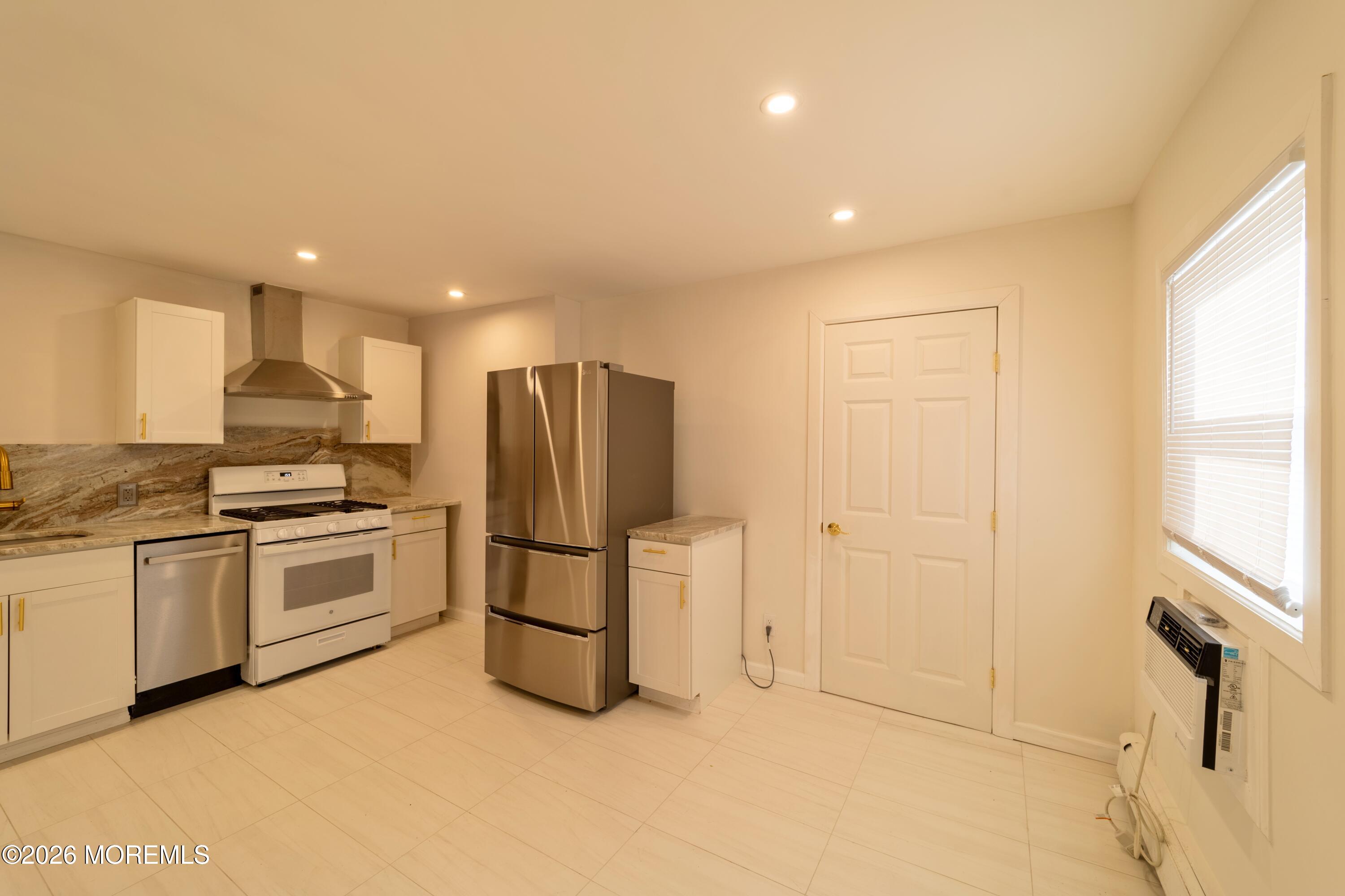 106 Wallace Street, Unit B Red Bank, NJ 07701 - Photo 12 of 20 a kitchen with a refrigerator and a stove top oven